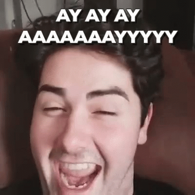 A Man With His Eyes Closed Is Making A Funny Face With His Tongue Out . GIF