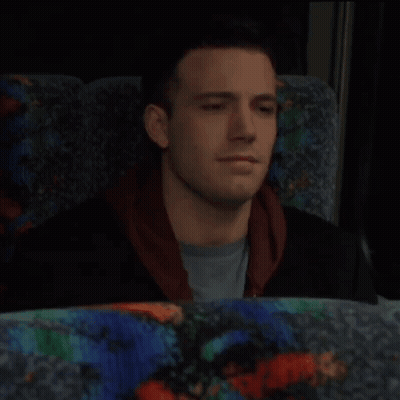 A Man With His Eyes Closed Is Sitting In A Colorful Seat GIF