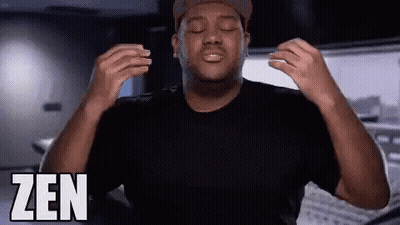 A Man With His Eyes Closed Is Wearing A Black Shirt And A Hat And The Word Zen Is On The Bottom Right GIF