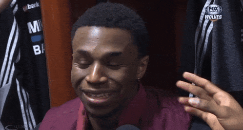 A Man With His Eyes Closed Is Wearing A Fox Sports Jersey GIF