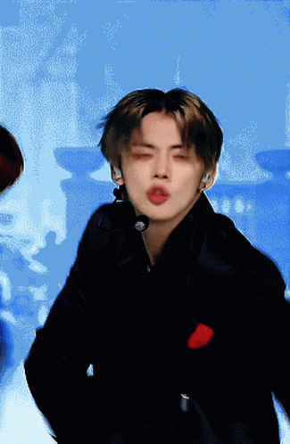 A Man With His Eyes Closed Is Wearing A Microphone On His Neck GIF
