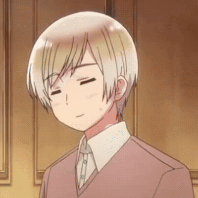 A Man With His Eyes Closed Is Wearing A Pink Sweater And White Shirt GIF
