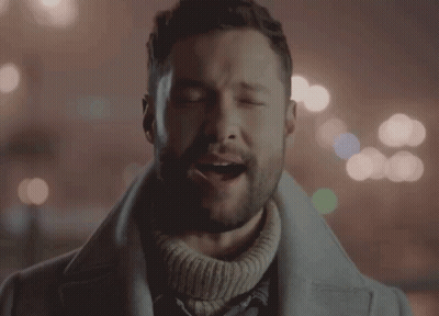 A Man With His Eyes Closed Is Wearing A Sweater GIF