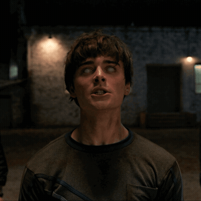 A Man With His Eyes Closed Looks Up At The Camera GIF