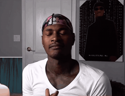 A Man With His Eyes Closed Stands In Front Of A Poster That Says Spiritual So GIF