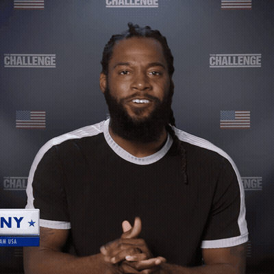 A Man With His Eyes Closed Stands In Front Of A Wall That Says The Challenge GIF