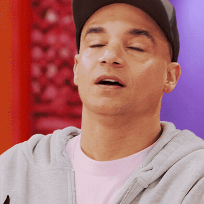 A Man With His Eyes Closed Wearing A Hat And A Gray Hoodie GIF