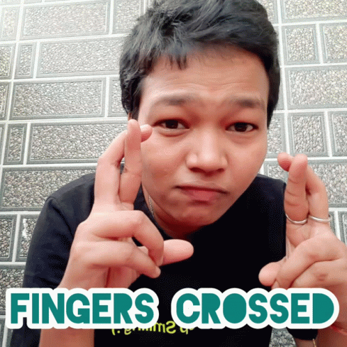 A Man With His Fingers Crossed And The Words Fingers Crossed GIF