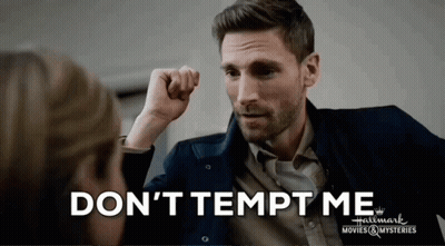 A Man With His Fist In The Air And The Words " Don 'T Tempt Me " Above Him GIF