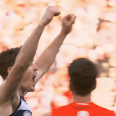 A Man With His Fist In The Air Is Wearing A Jersey That Says Afl GIF