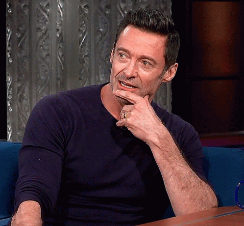 A Man With His Hand On His Chin And A Ring On His Finger GIF