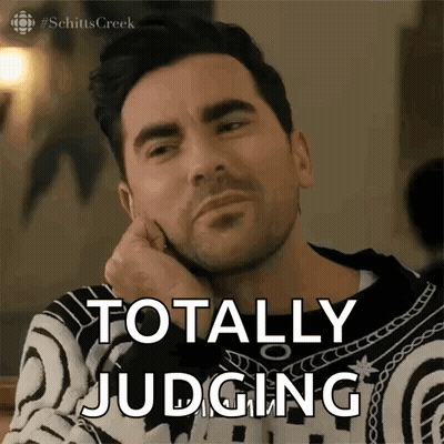 A Man With His Hand On His Chin Says Totally Judging . GIF