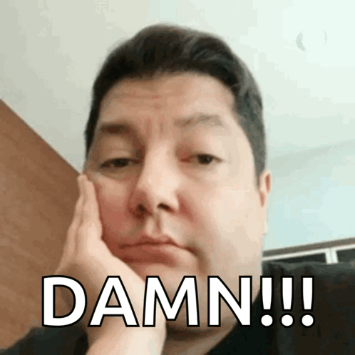 A Man With His Hand On His Face And The Word Damn Written On His Face GIF