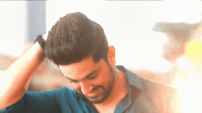 A Man With His Hand On His Head Looks Down GIF