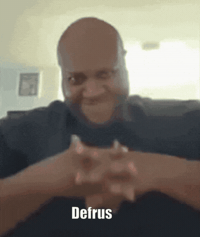 A Man With His Hands Folded And The Word Defrus On The Bottom Right GIF