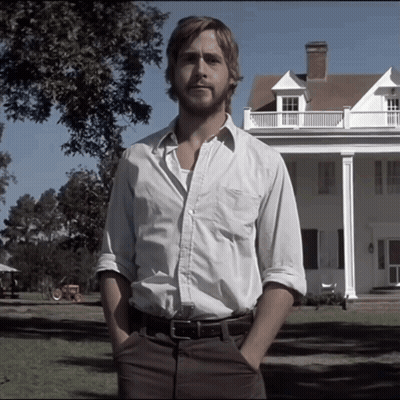 A Man With His Hands In His Pockets Stands In Front Of A Large White House GIF