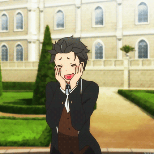 A Man With His Hands On His Face Stands In Front Of A Large Building GIF