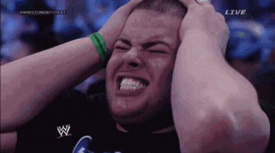 A Man With His Hands On His Head Is On A Wrestling Show GIF