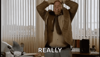 A Man With His Hands On His Head Is Standing In Front Of A Window With The Word Really Written On It . GIF