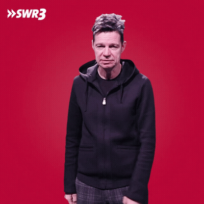 A Man With His Hands On His Hips Is Standing In Front Of A Red Background With Swr3 Written On It GIF