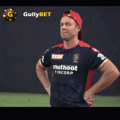 A Man With His Hands On His Hips Wears A Shirt That Says Exide Muthoot Fincorp GIF