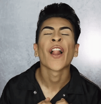 A Man With His Mouth Open And His Tongue Sticking Out GIF