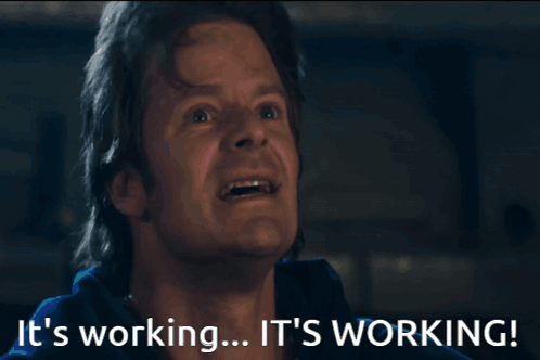 A Man With His Mouth Open And The Words " It 'S Working " Behind Him GIF