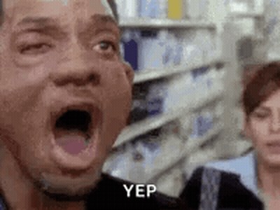 A Man With His Mouth Open In A Store With A Woman Behind Him . GIF