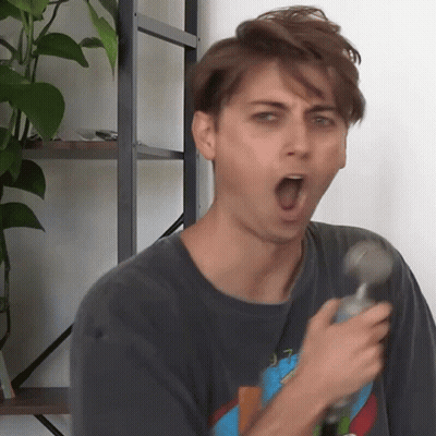a man with his mouth open is holding a hammer in his hand