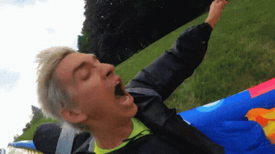 A Man With His Mouth Open Is Laying On A Colorful Raft GIF