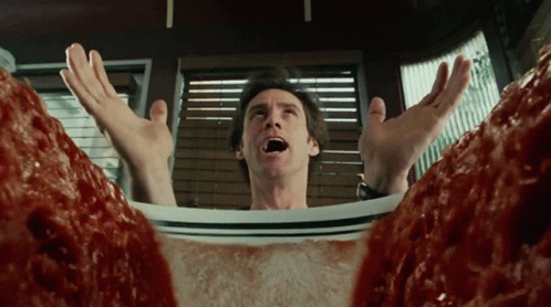 A Man With His Mouth Open Is Laying On A Plate Of Meatballs GIF
