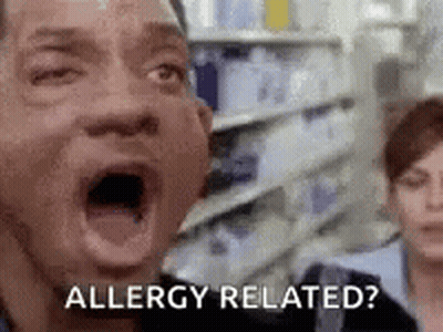 A Man With His Mouth Open Is Saying `` Allergy Related ? '' In A Grocery Store . GIF