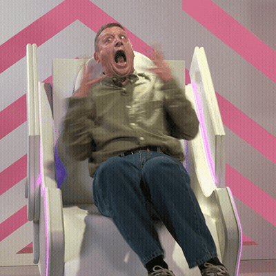 A Man With His Mouth Open Is Sitting In A Chair GIF