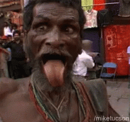 A Man With His Tongue Hanging Out Is Standing In Front Of A Clothesline GIF