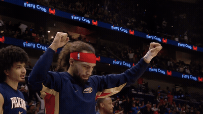 a man with his tongue out wearing a fiery crab headband