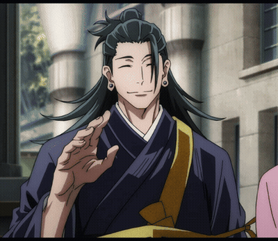 A Man With Long Black Hair And A Ponytail Is Smiling GIF