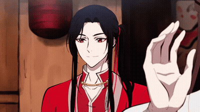 A Man With Long Black Hair And Red Eyes Is Giving A High Five GIF