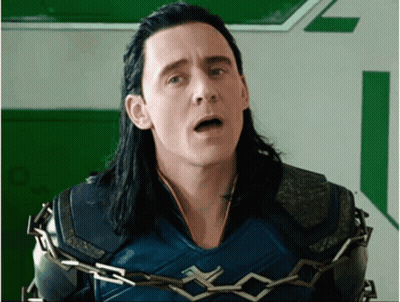 A Man With Long Black Hair Is Chained To A Wall With His Mouth Open . GIF