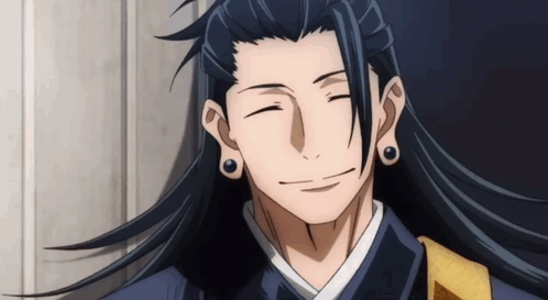 A Man With Long Black Hair Is Smiling With His Eyes Closed GIF