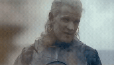 A Man With Long Blonde Hair And A Beard Is Wearing A Knight 'S Armor . GIF