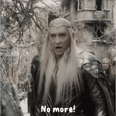 A Man With Long Blonde Hair And A Crown On His Head Is Standing In Front Of A Group Of People . GIF