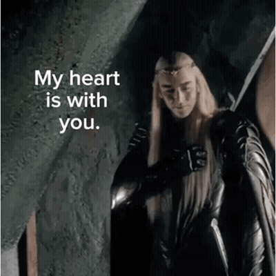 A Man With Long Blonde Hair Is Holding A Sword And Says My Heart Is With You . GIF