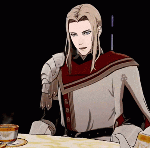 A Man With Long Blonde Hair Is Sitting At A Table With A Cup Of Tea GIF