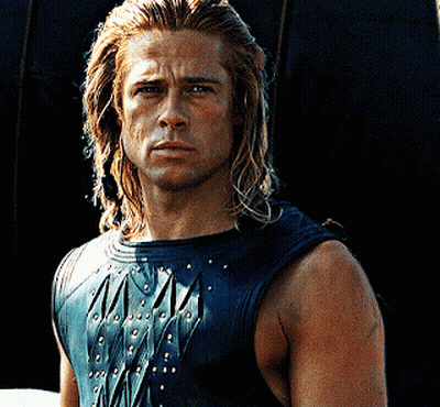 A Man With Long Blonde Hair Is Wearing A Black Leather Vest GIF