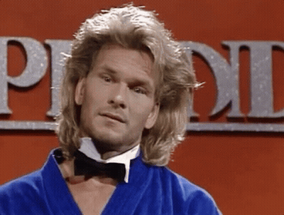 A Man With Long Blonde Hair Is Wearing A Bow Tie And A Blue Robe GIF