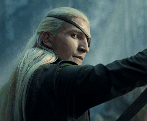 A Man With Long Blonde Hair Is Wearing A Pirate Eye Patch GIF