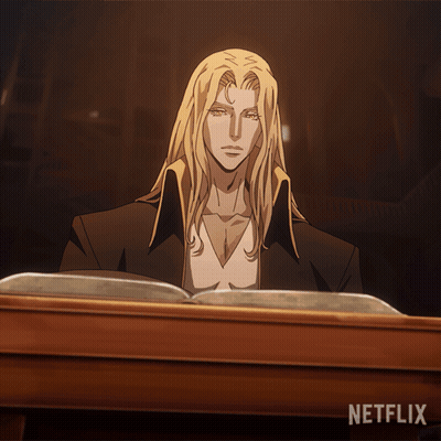 A Man With Long Blonde Hair Sits At A Table Reading A Book With Netflix Written On The Bottom GIF