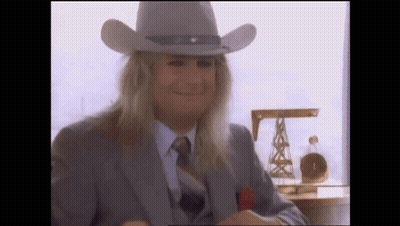 A Man With Long Blonde Hair Wearing A Cowboy Hat GIF