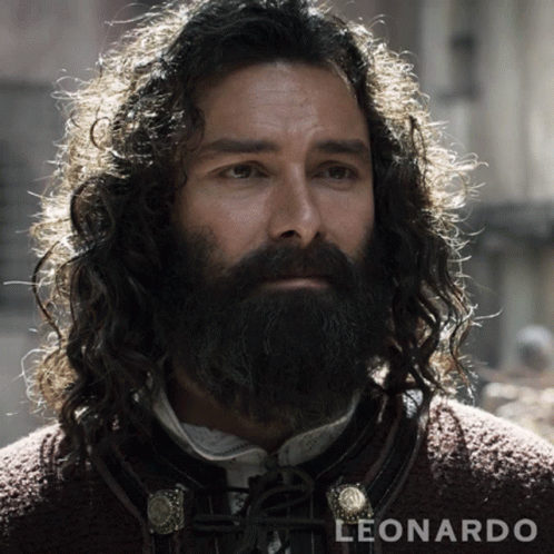 A Man With Long Curly Hair And A Beard Is Named Leonardo GIF