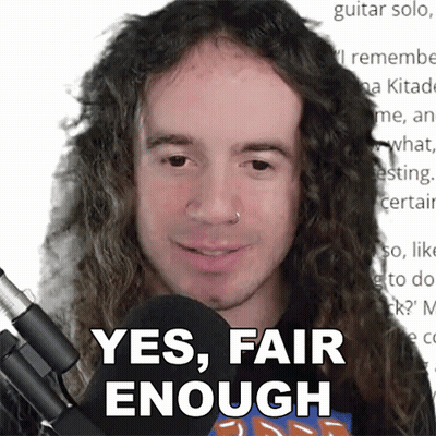 A Man With Long Curly Hair Is Smiling And Says Yes Fair Enough GIF
